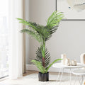 Potted plant in a modern living room with a white table and decor.