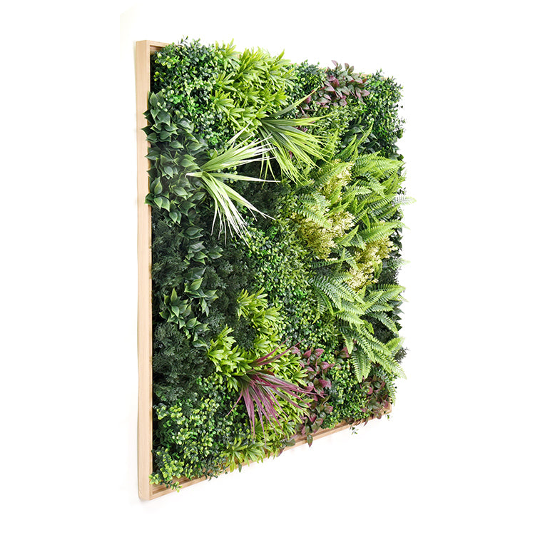 Artificial vertical garden panel with greenery on a white background